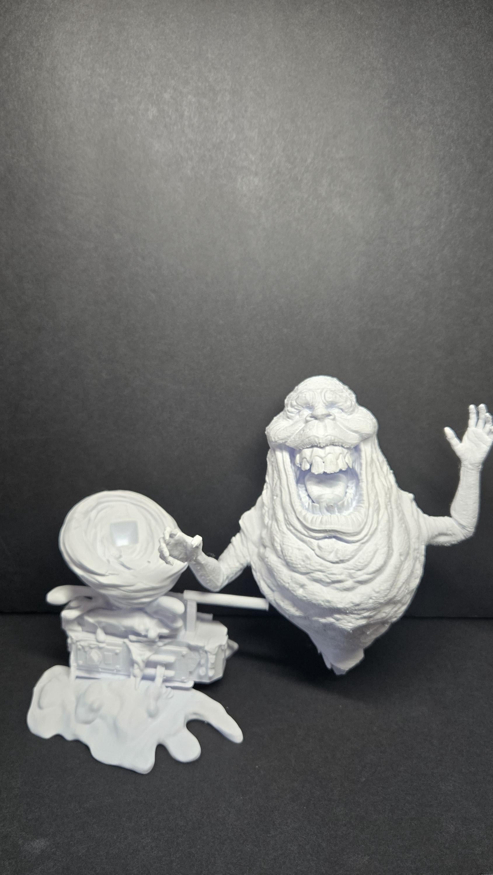 The 3D printed Library Ghost diorama disassembled into its modular parts, showing the ghost figure separated from the slime-textured base