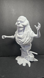 Side profile view of the unpainted Library Ghost statue highlighting the ghostly body and slime-textured base