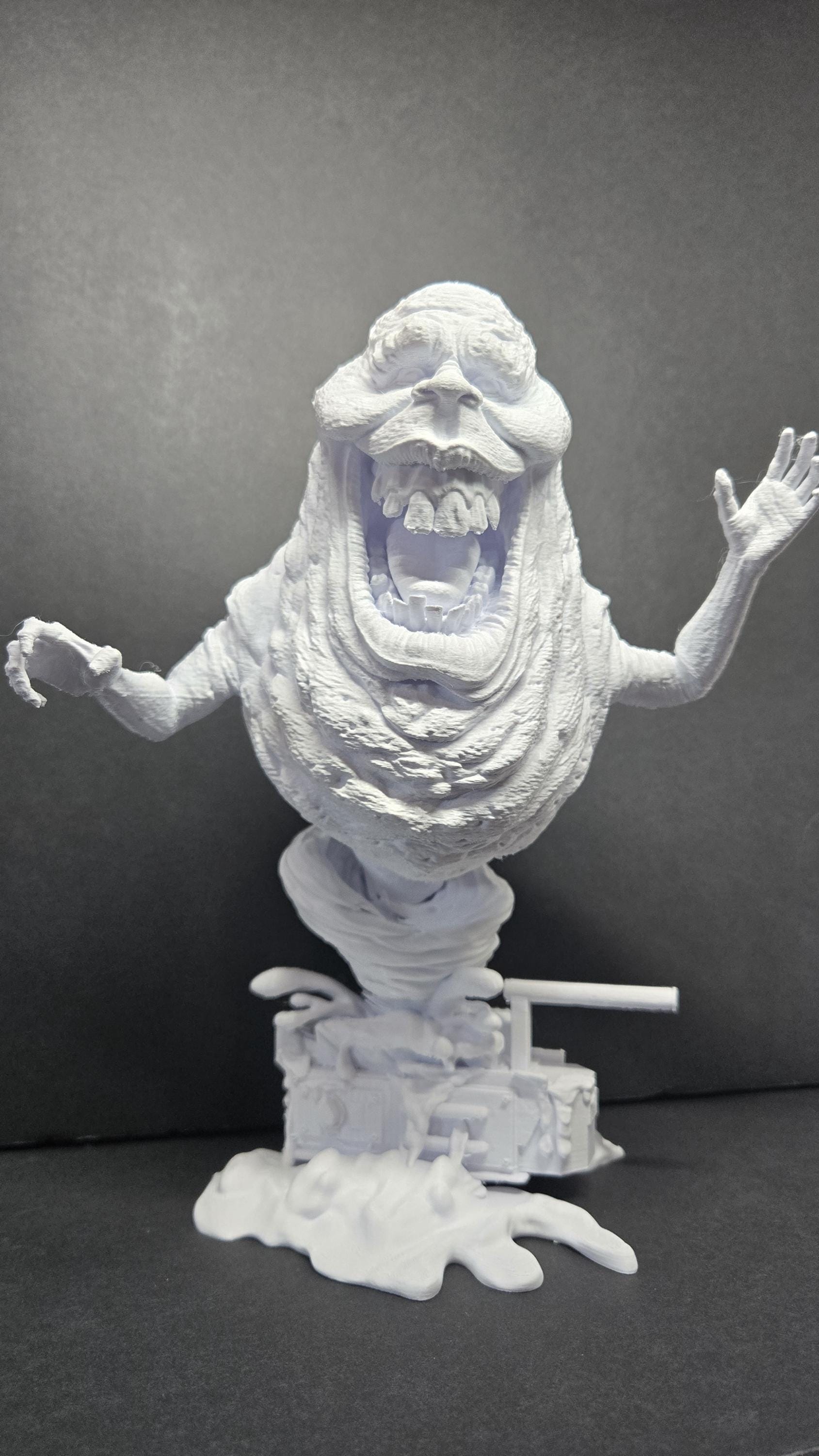 Straight front view of the unpainted 3D printed Library Ghost diorama on a black background showing the ghost on a slime-textured base