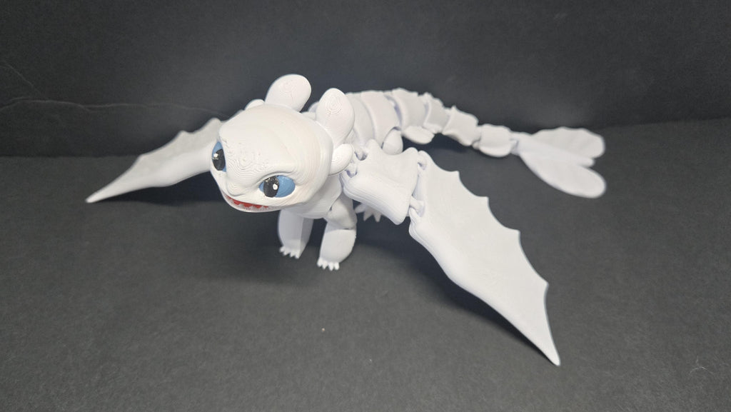 Light Fury flexi dragon figure posed in a dynamic flight stance