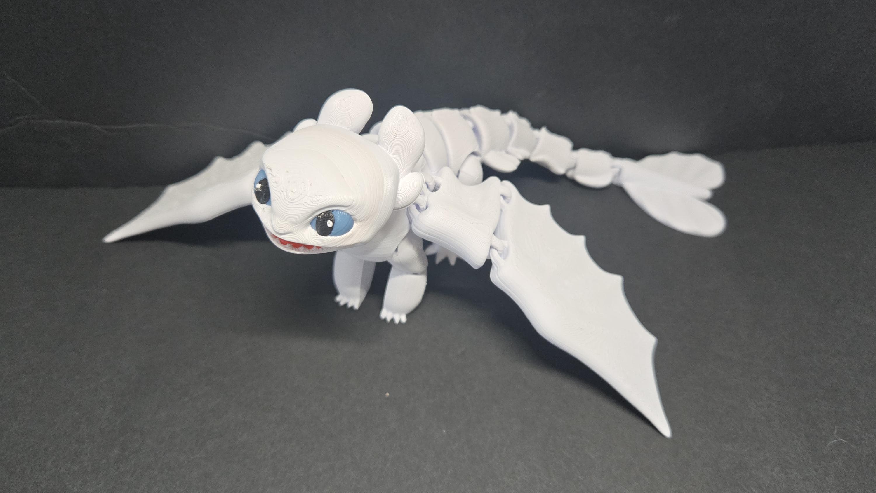 Light Fury flexi dragon figure posed in a dynamic flight stance