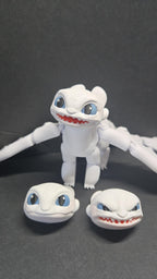 Light Fury articulated dragon figure shown alongside all three swappable head expressions