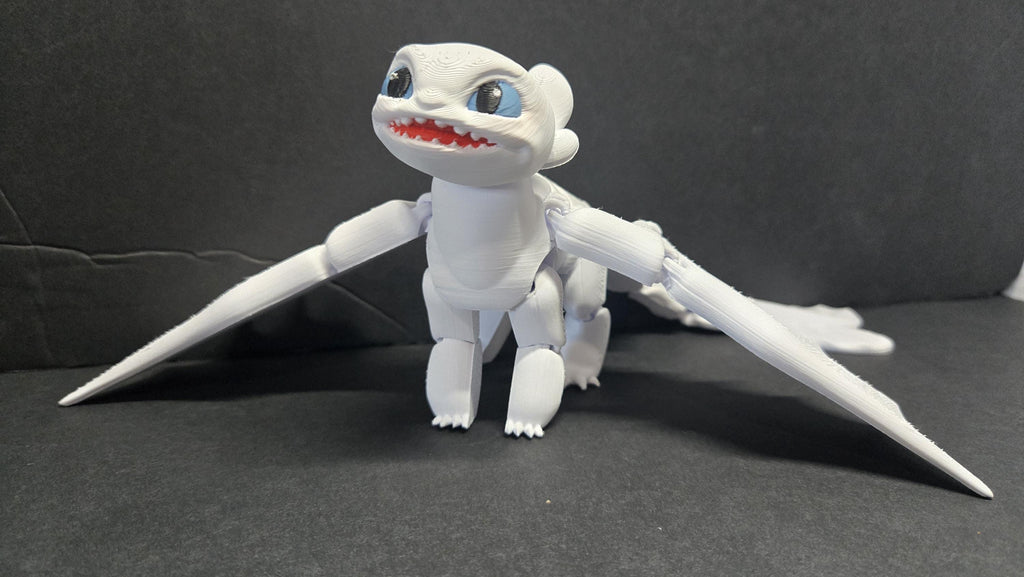 Full-color 3D printed Light Fury flexi figure with wings spread standing in a display-ready pose