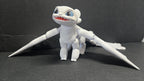 Full-color 3D printed Light Fury flexi figure with wings spread standing in a display-ready pose