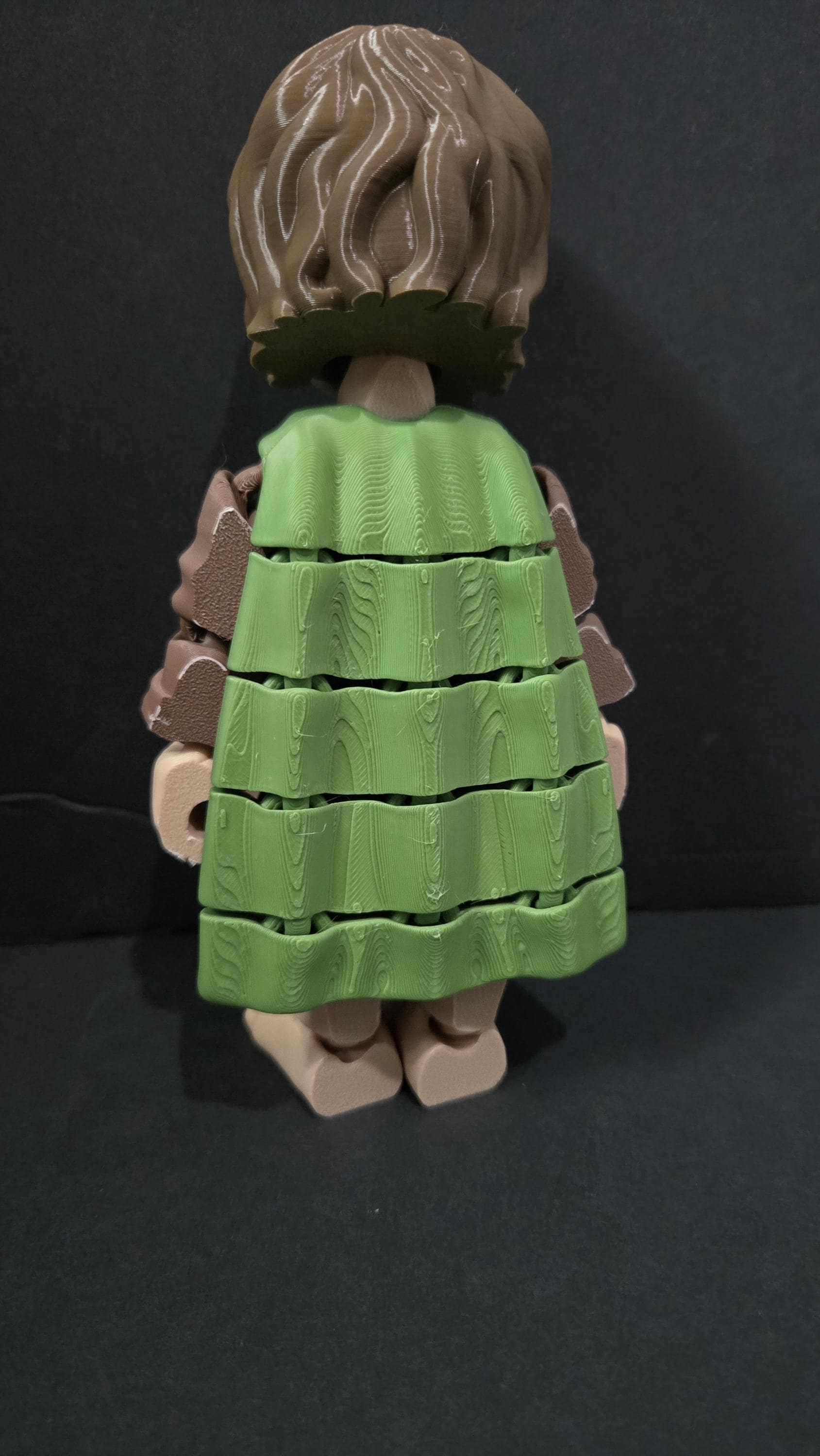 Rear view of the 3D printed Frodo Baggins figurine showcasing the clean jointed interlocking segments along the back of his green cloak