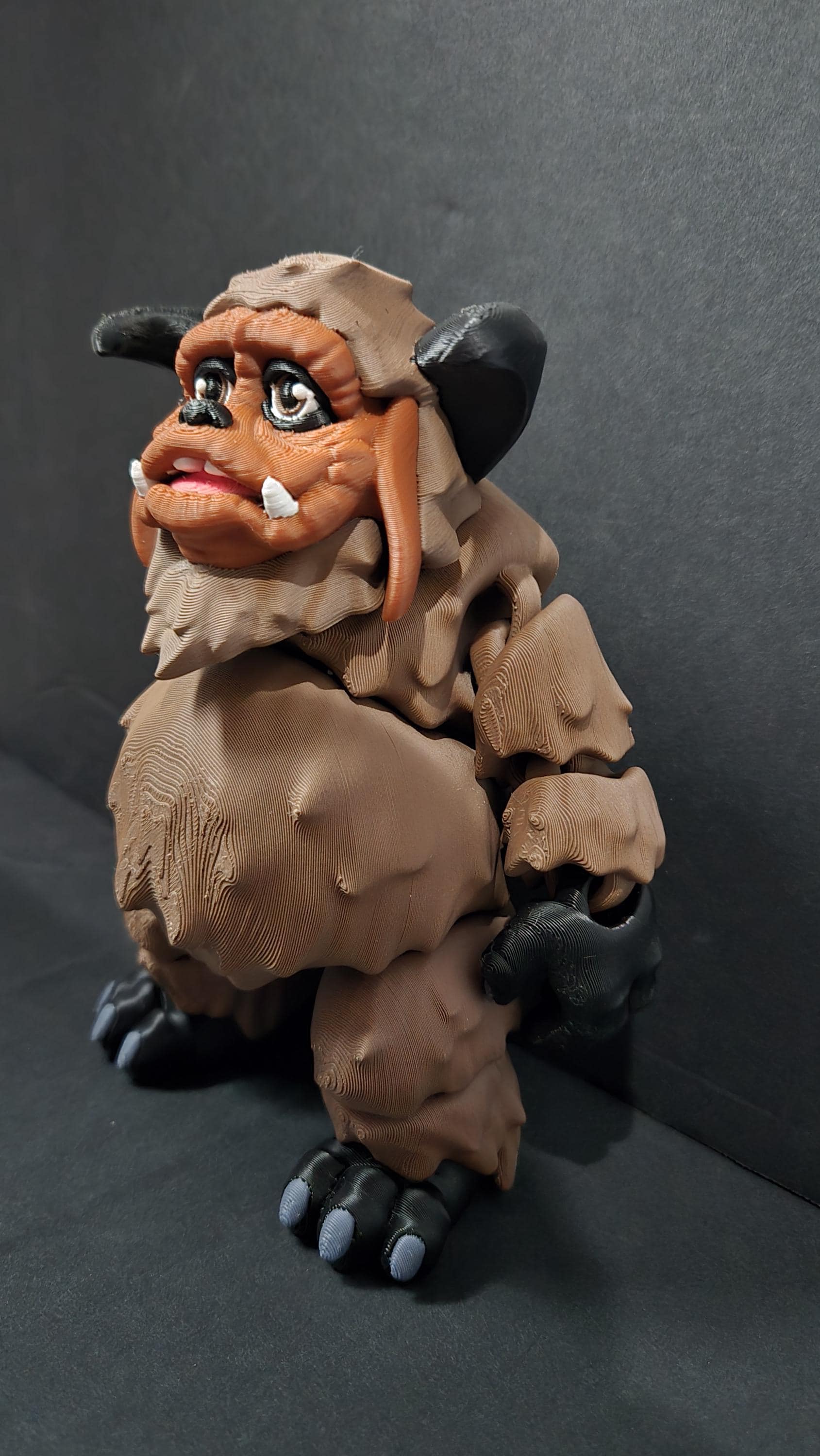 Left side profile view of the flexible Ludo monster toy showing his massive build, arm articulation joints, and side head profile