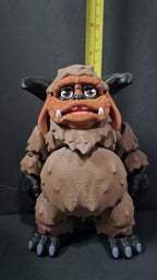 Straight front-on view focusing on the detailed face, large curved horns, and friendly expression of the flexible Ludo figure