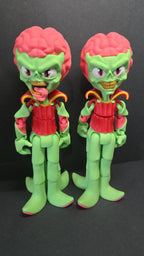 Straight front view focusing on the giant exposed brain, bloodshot eyes, and skull-like face of the flexible Martian figure