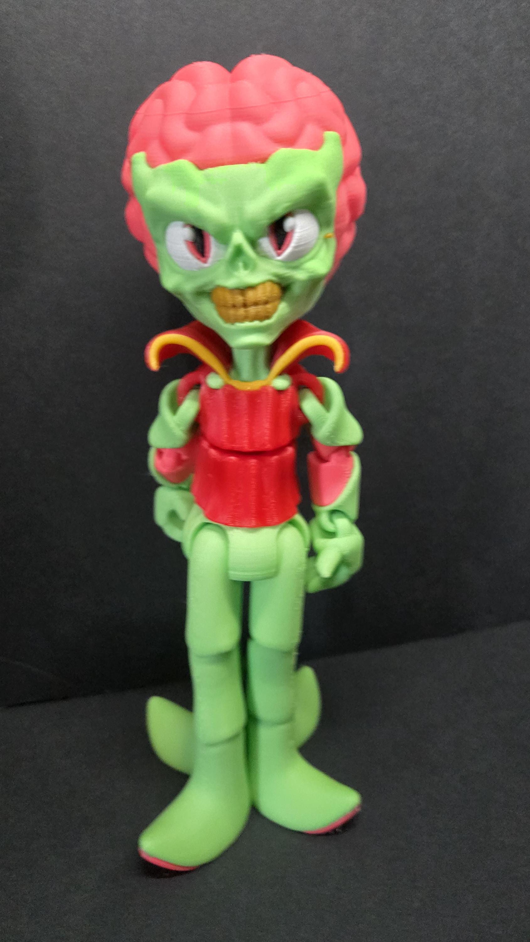 Straight front view focusing on the giant exposed brain, bloodshot eyes, and skull-like face of the flexible Martian figure