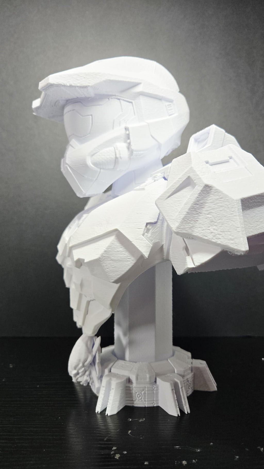 Three-quarter left profile view of the 3D printed Spartan-117 statue highlighting the sleek neck joints and heavy collar plating