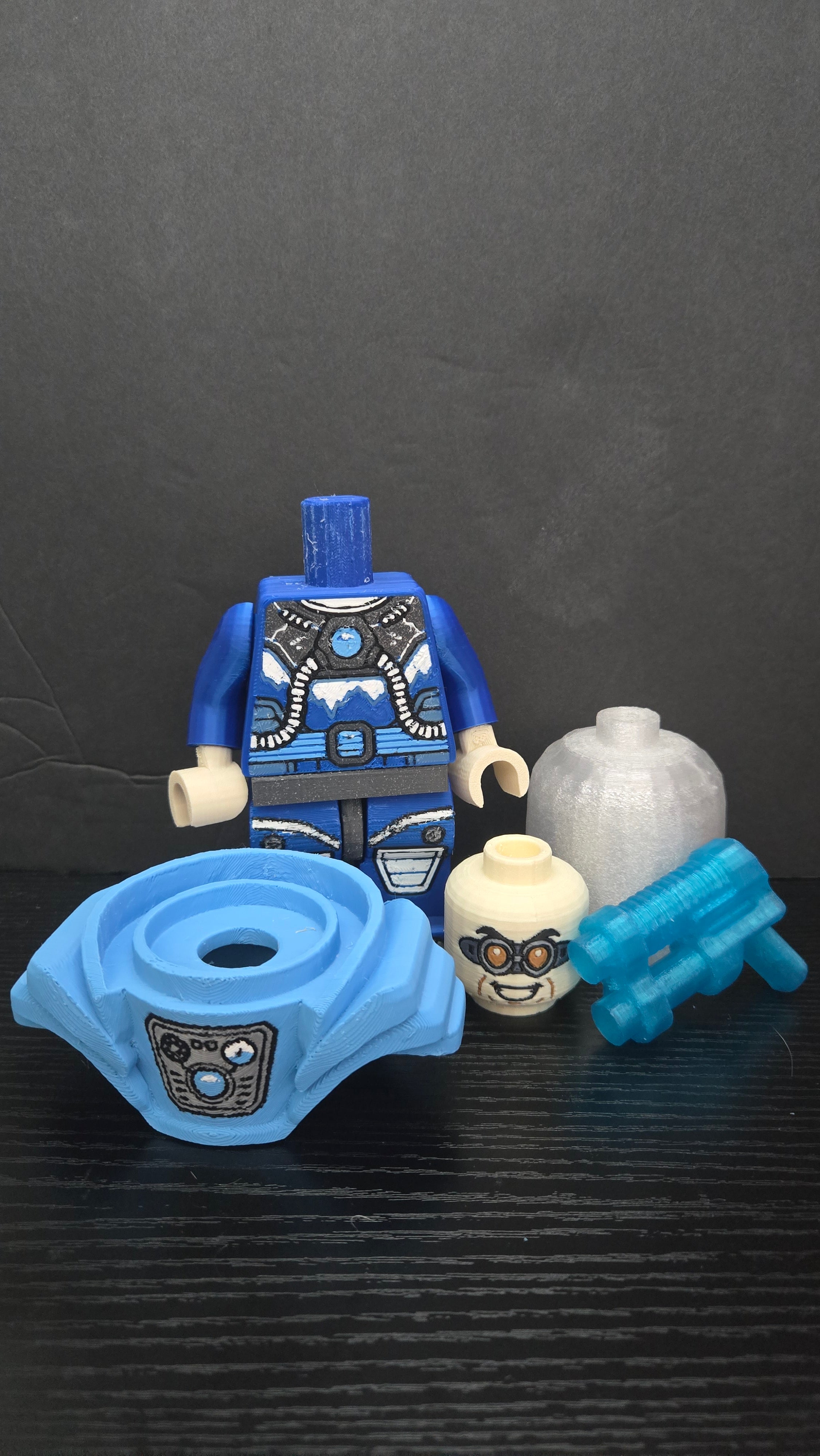 Mr. Freeze brick megafig shown broken down into torso, shoulder armor, head, helmet, and freeze gun parts
