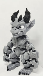 Left side profile view of the flexible gargoyle monster toy showing the wing curvature and arm articulation joints