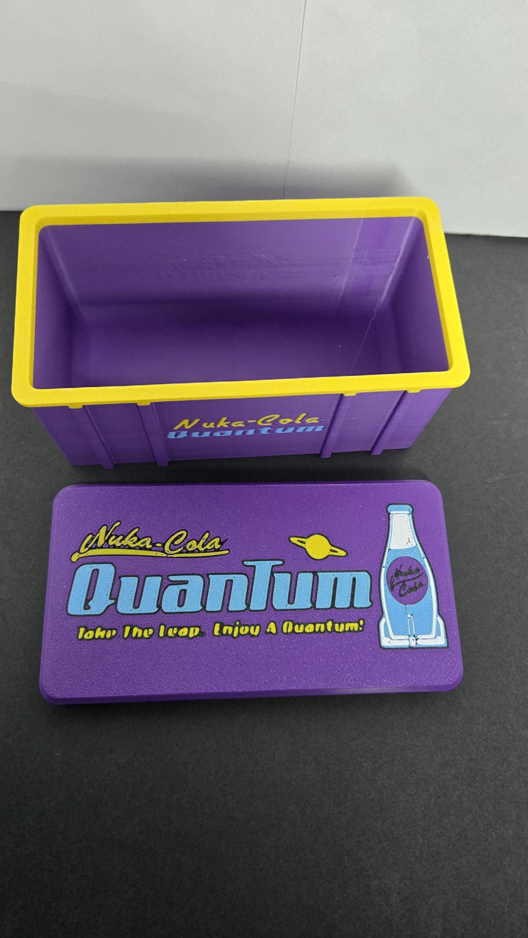 Open view of the Nuka-Cola Quantum storage case showing the spacious purple interior and yellow trim
