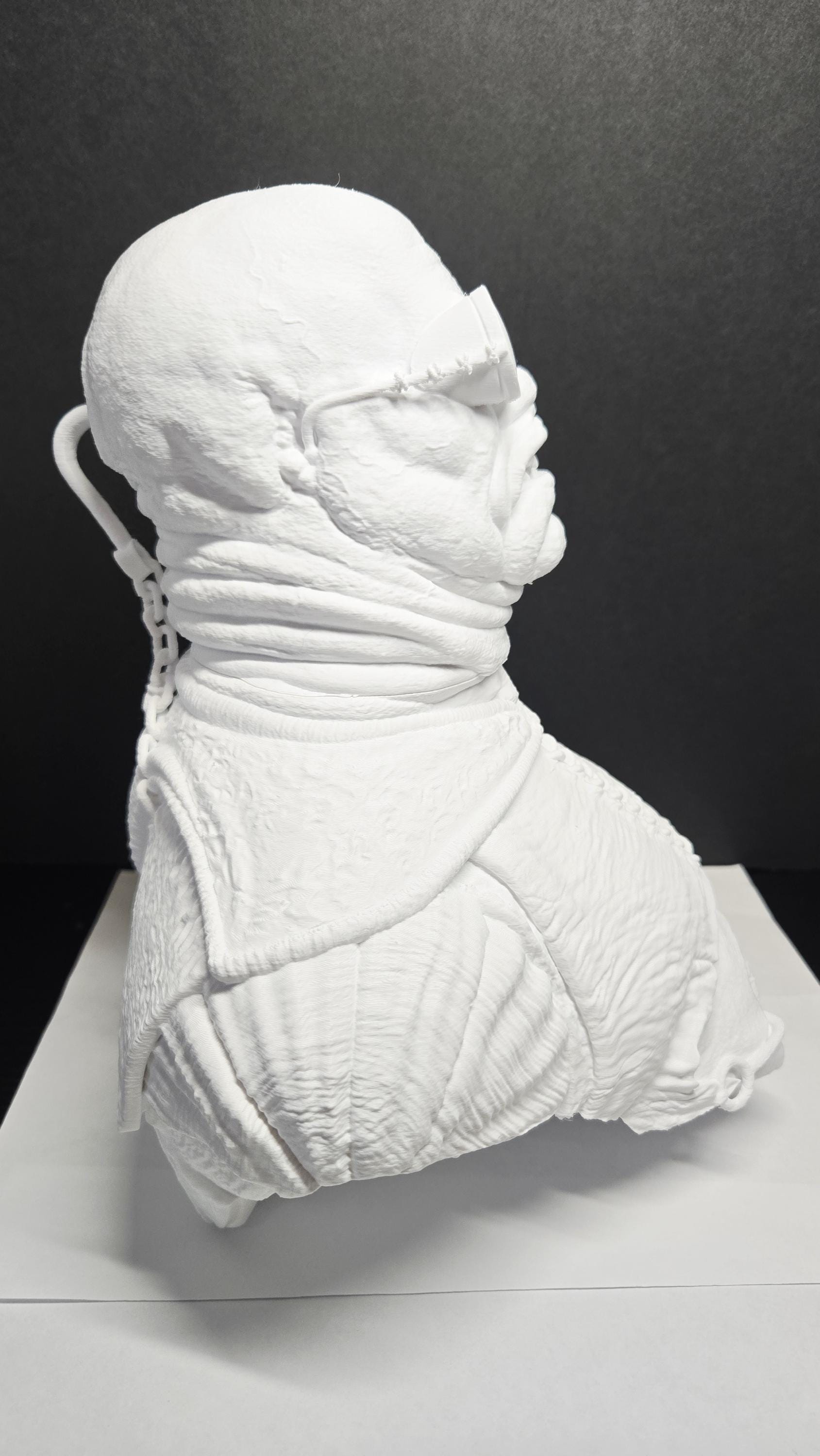 Right side profile view of the raw 3D printed movie monster model displaying its round frame and paint-ready surface