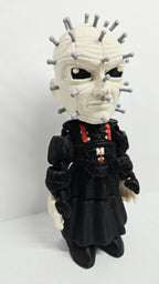Three-quarter right side view of the flexible Pinhead figure showcasing the head detail, arm joints, and robe texture