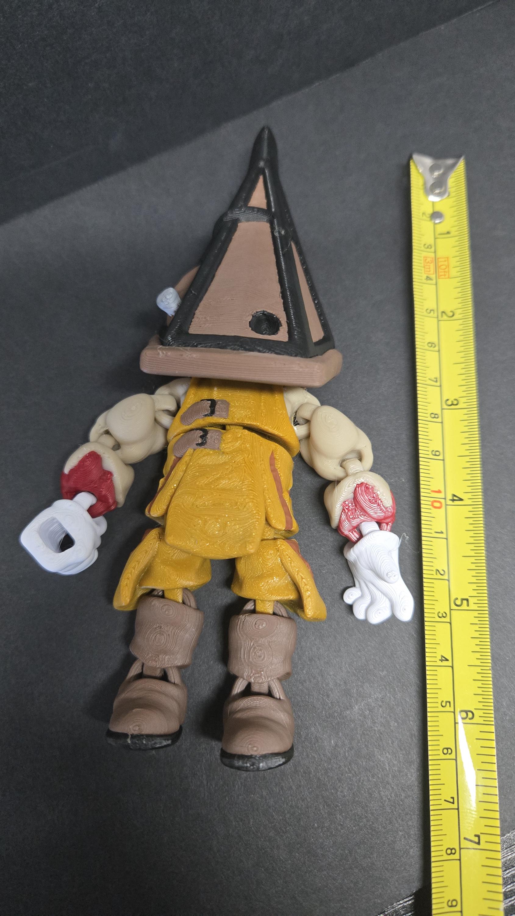 A vertical yellow measuring tape placed alongside the standing multi-color Pyramid Head flexi figure to display its exact physical height