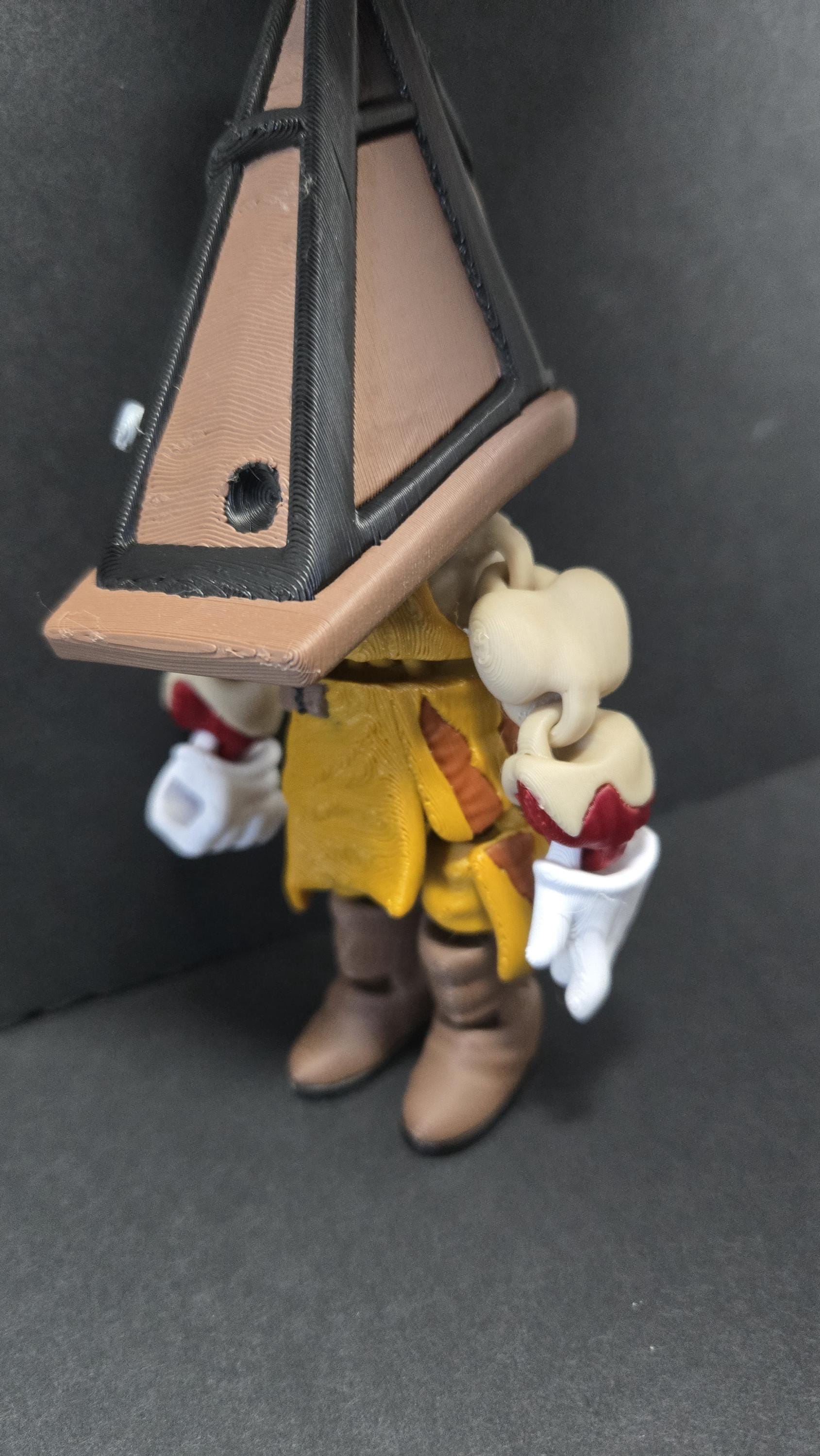 Three-quarter left profile view of the 3D printed Pyramid Head figurine highlighting the clean multi-color print transitions