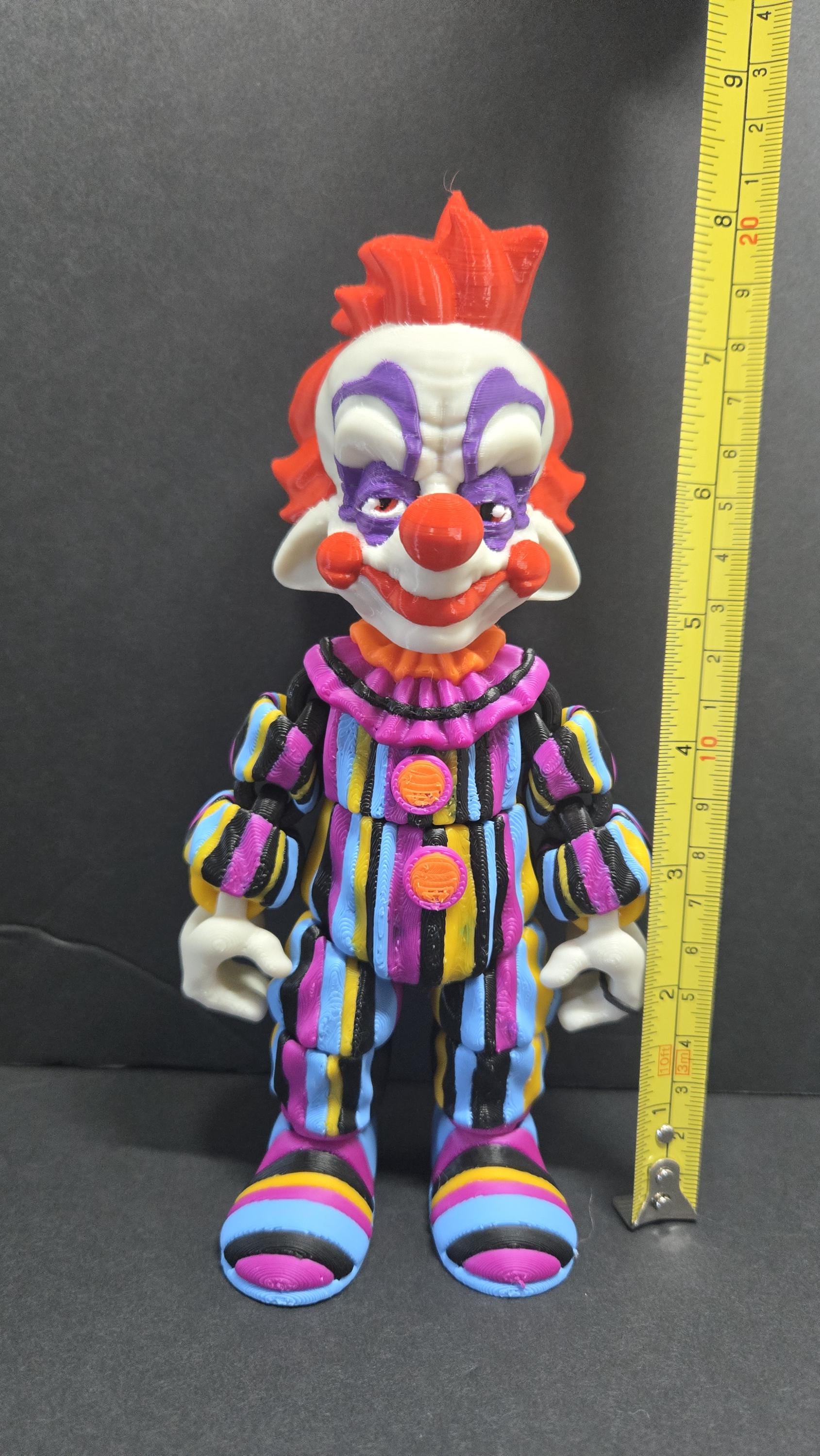 Yellow measuring tape showing the 8-inch height of the 3D printed Rudy flexi figure