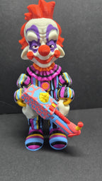 Straight front view of the 3D printed Rudy flexi figure posed holding his colorful popcorn gun