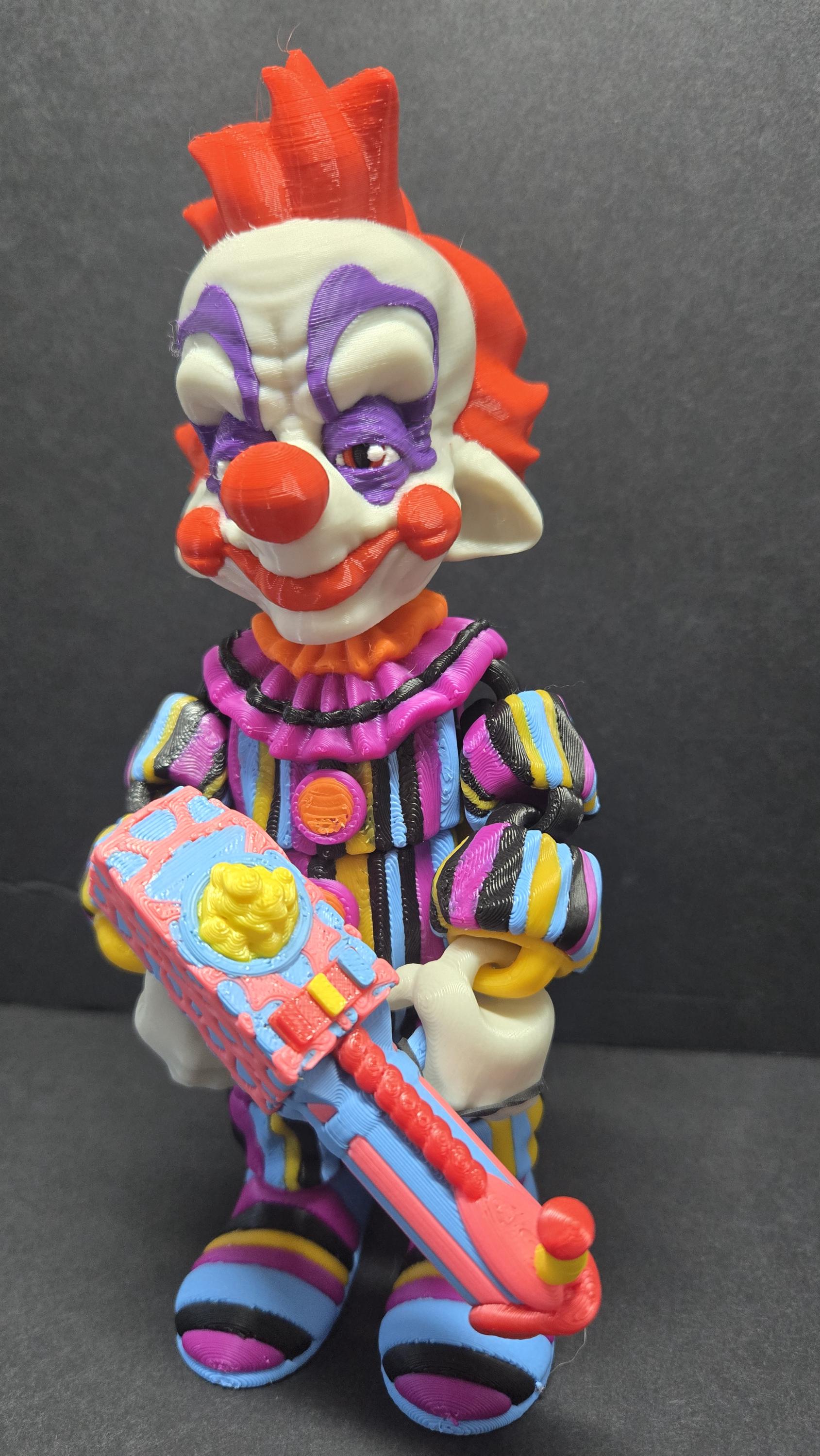 Left side profile view of the 3D printed Rudy flexi figure showing articulation and popcorn gun detail