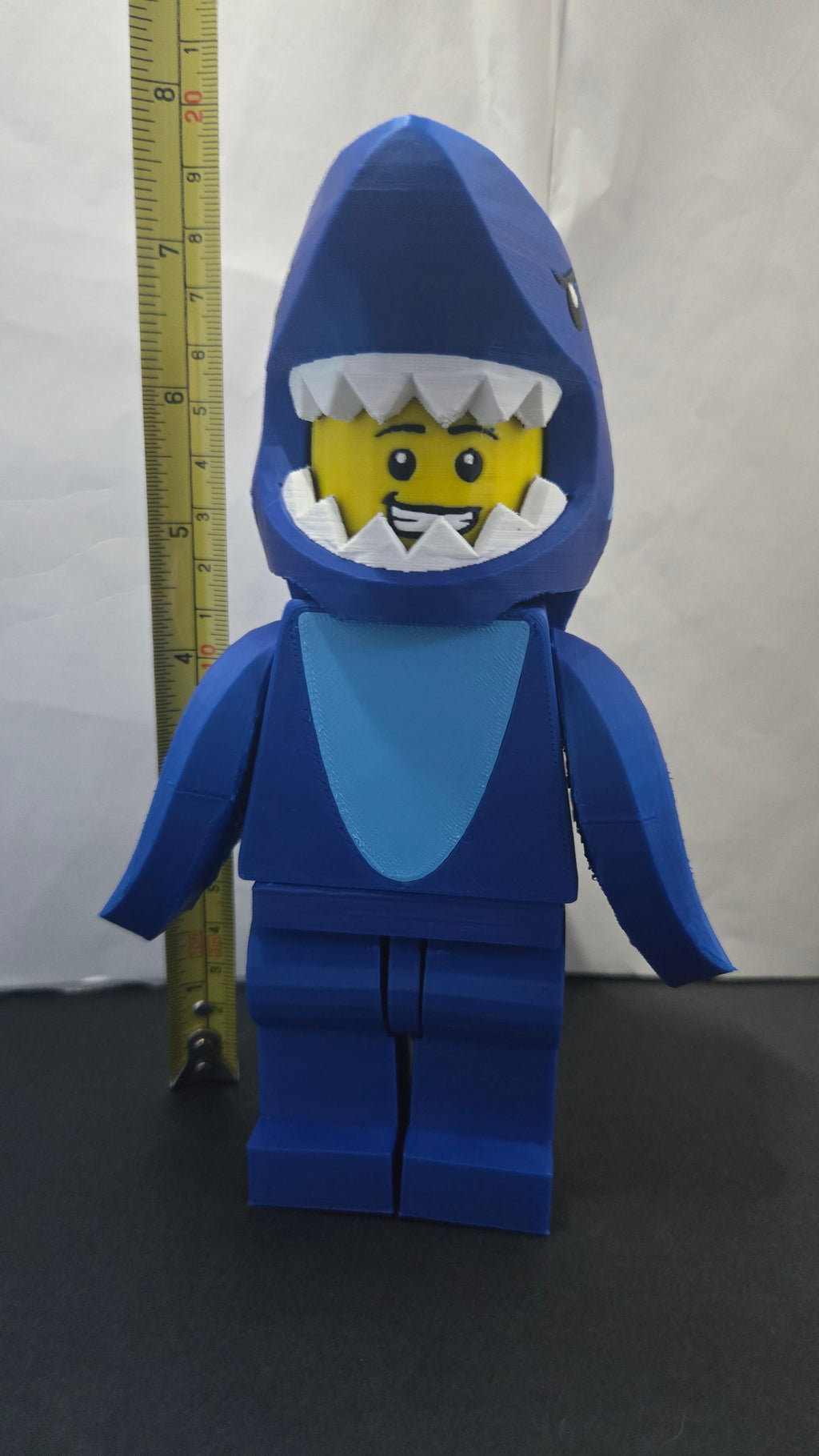 Measuring tape showing the towering height of the scaled oversized Shark Suit megafig