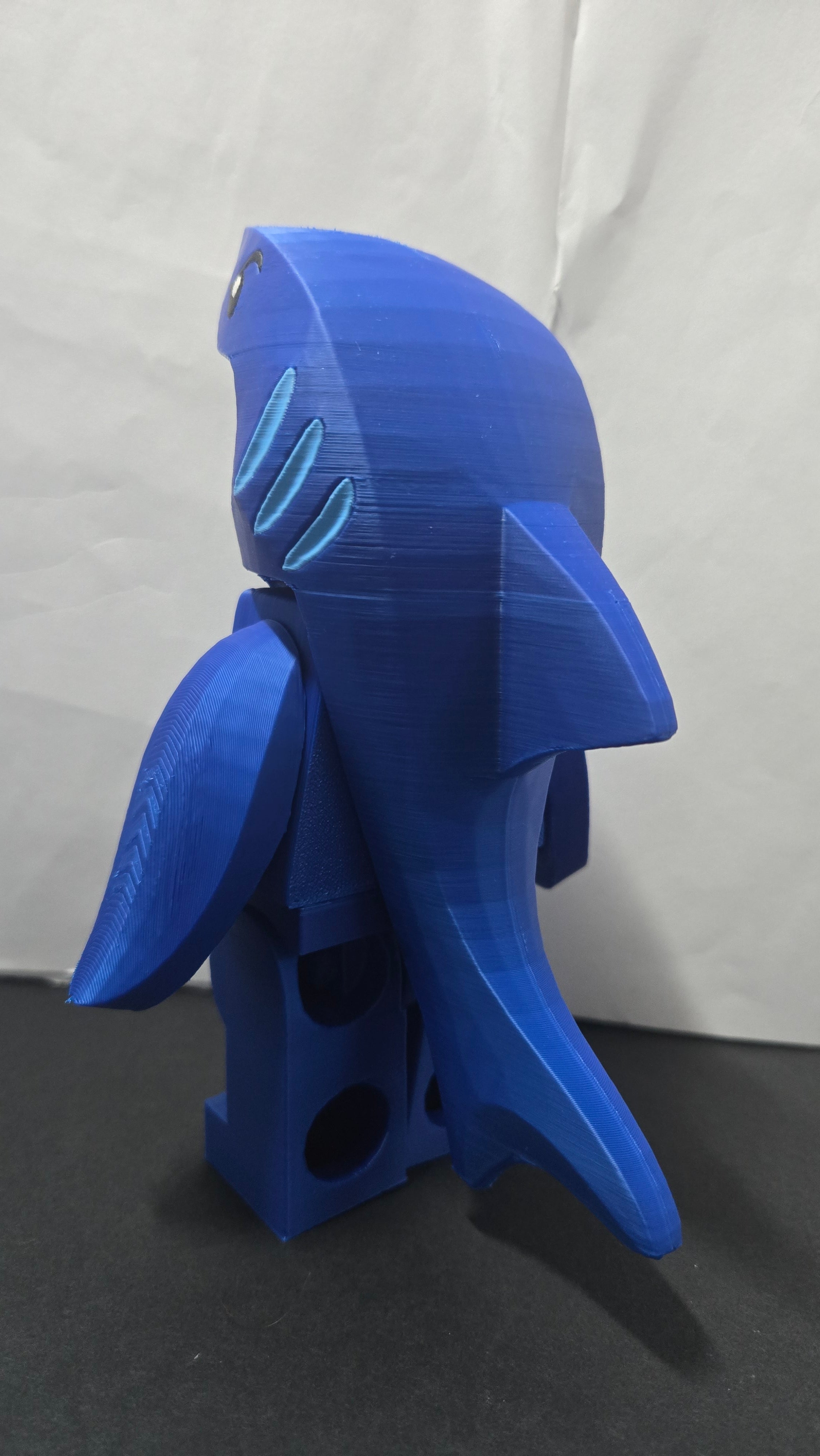 Rear profile view of the oversized Shark Suit brick megafig showing back details and fin