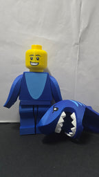 Shark Suit megafig shown with the shark hood removed next to the body to reveal the minifigure face