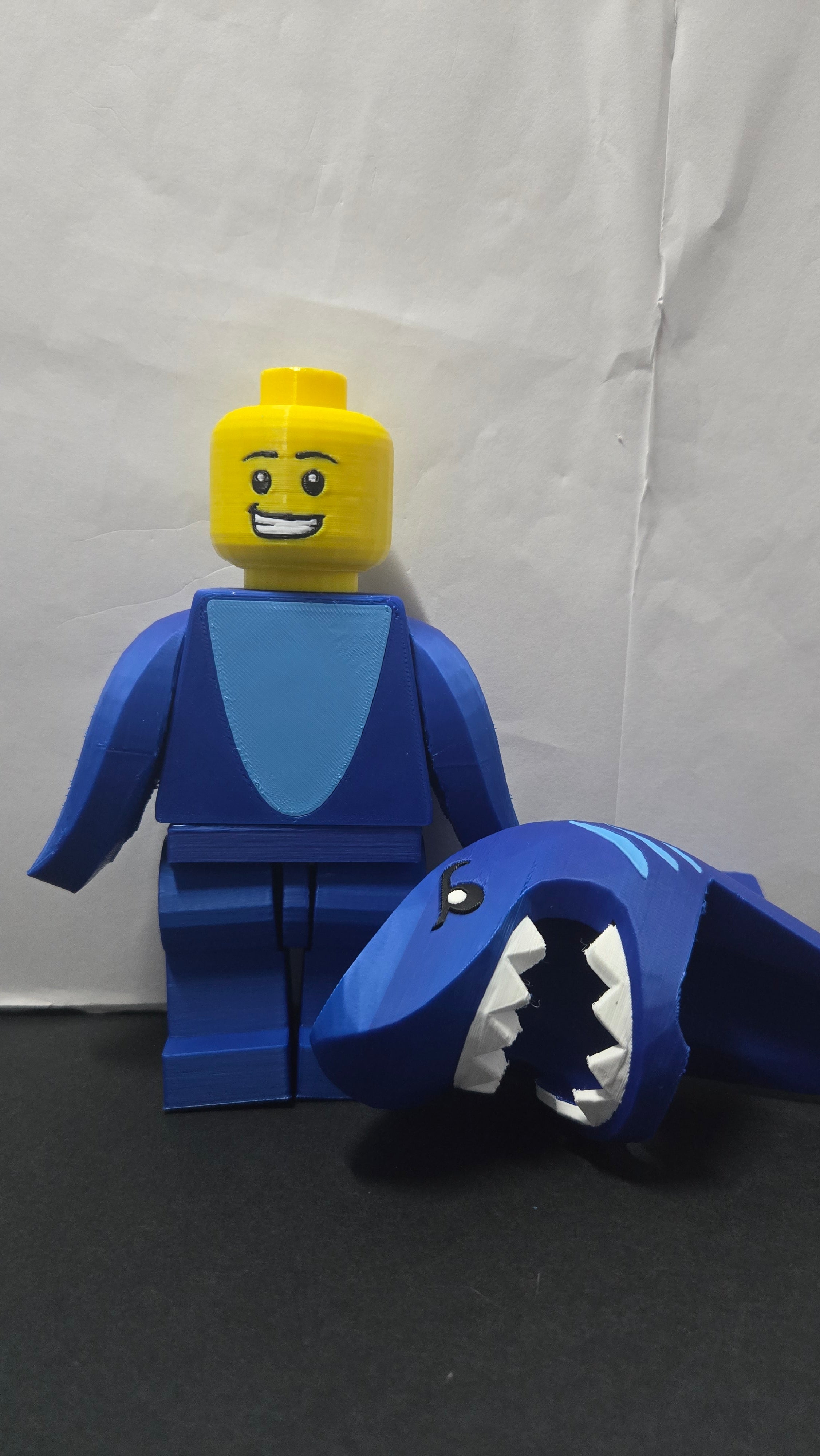 Shark Suit megafig shown with the shark hood removed next to the body to reveal the minifigure face