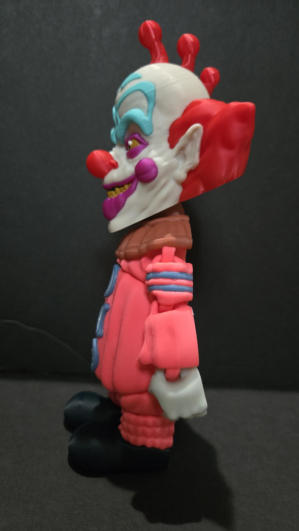 Left side profile view of the 3D printed Slim flexi figure showcasing his poseable limbs and jointed segments