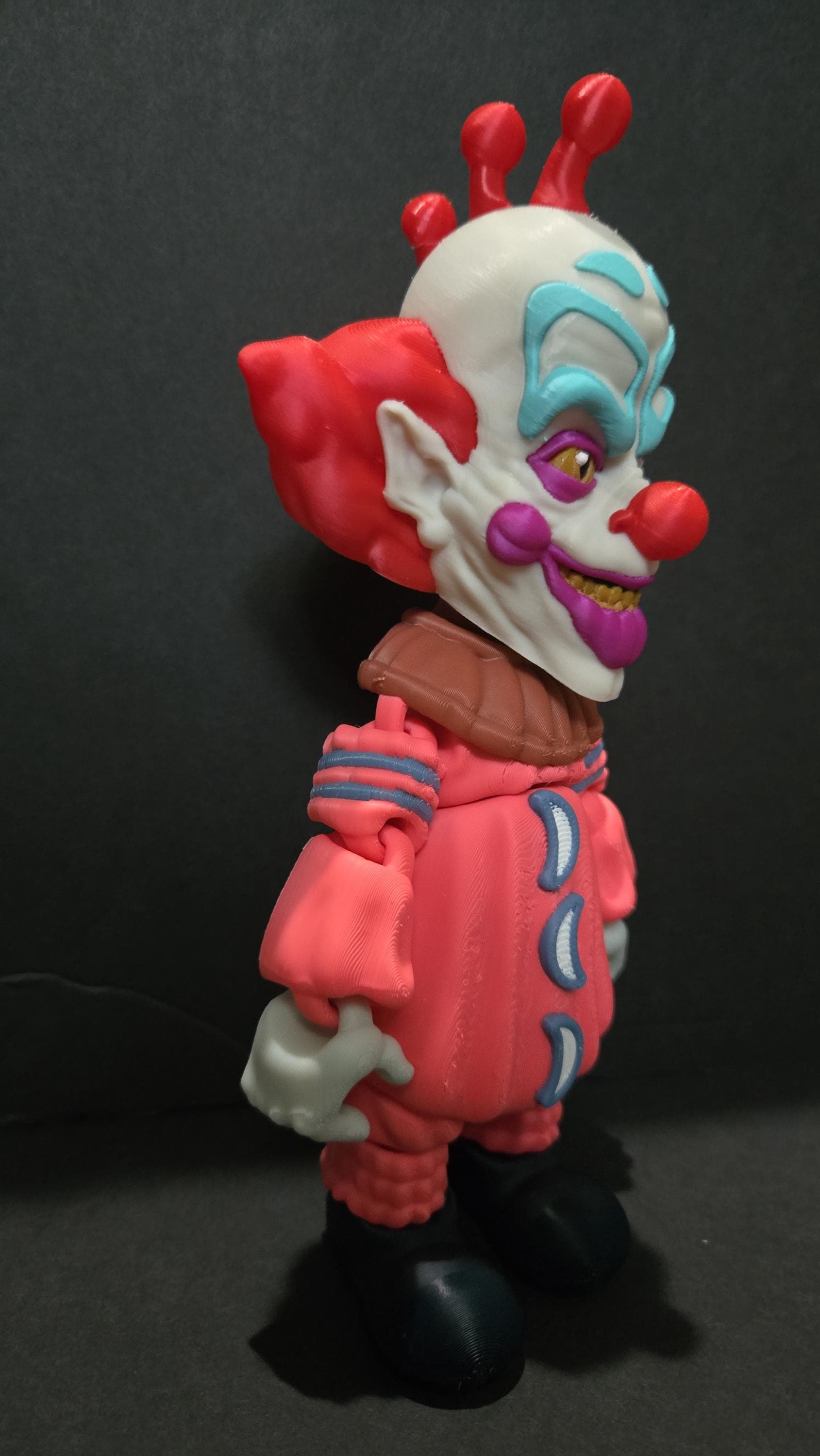 Side profile view of the 3D printed Slim flexi figure showing his articulation and suit detail