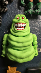 Straight front view of the 3D printed slimy ghost flexi figure showing his wide, toothy grin