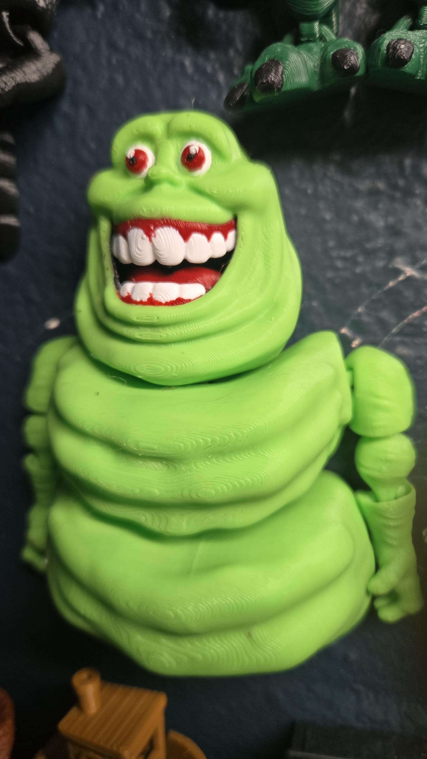 Three-quarter view of the 3D printed slimy ghost flexi figure showcasing his articulated joints and body texture