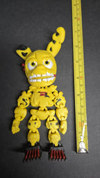 A vertical yellow measuring tape placed alongside the standing multi-color Spring Trap Bonnie flexi figure to display its exact physical height