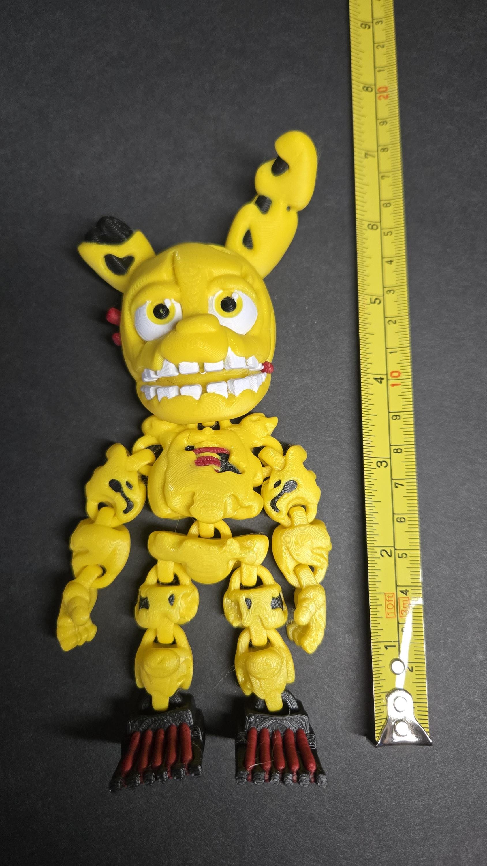 A vertical yellow measuring tape placed alongside the standing multi-color Spring Trap Bonnie flexi figure to display its exact physical height