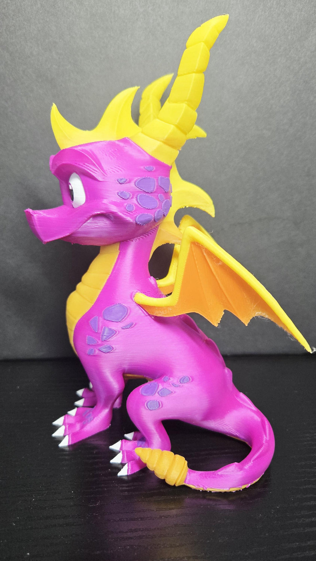 Three-quarter left side view of the 3D printed Spyro figure showcasing his heroic posture and detailed sculpt