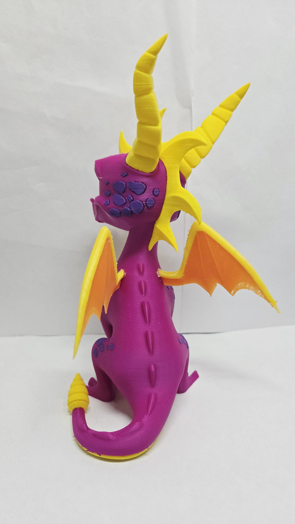 Rear view of the 3D printed Spyro figurine highlighting the tail and wing detail