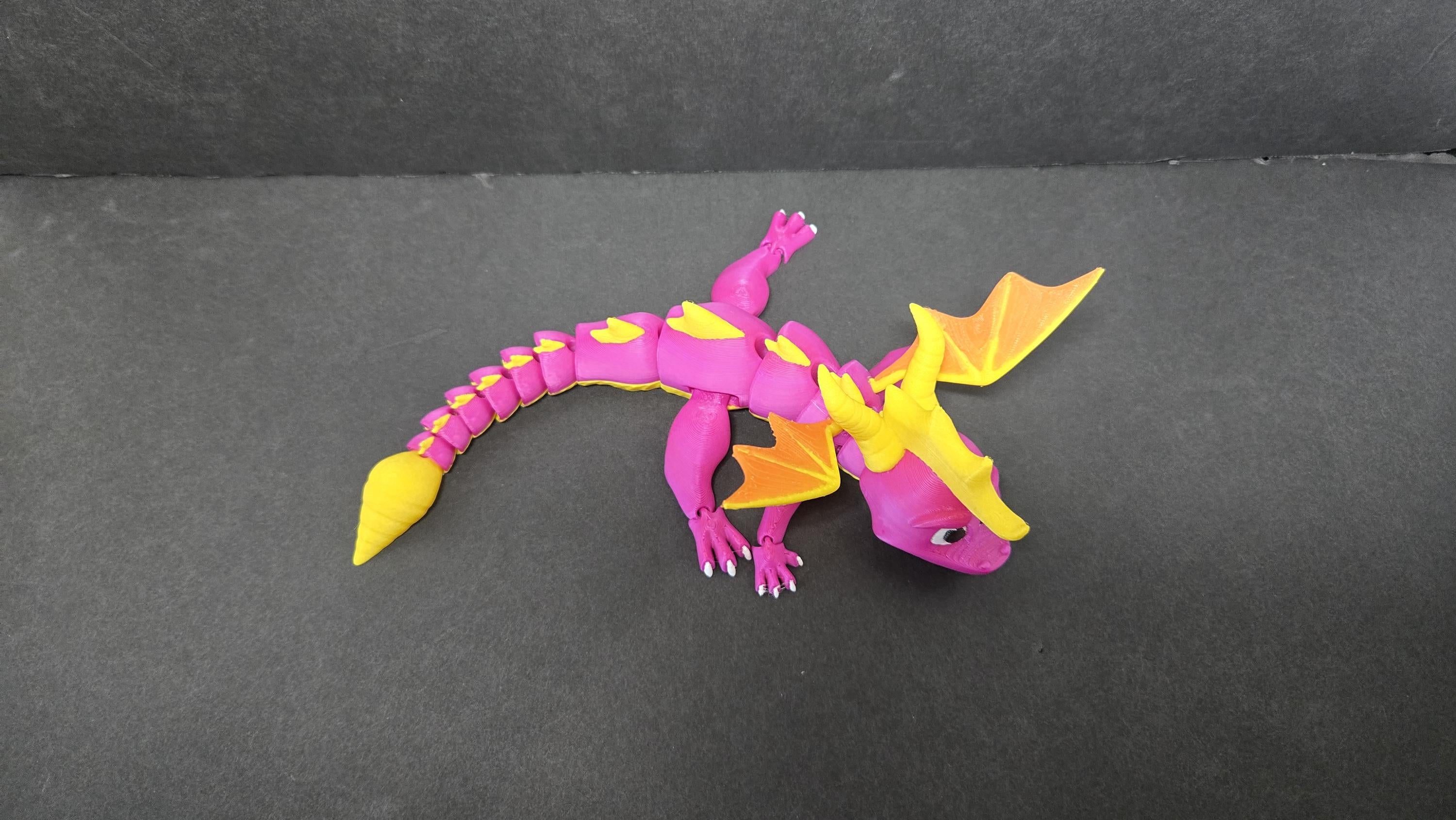 Spyro flexi figure posed in a low, charging stance to highlight his articulated limbs and tail