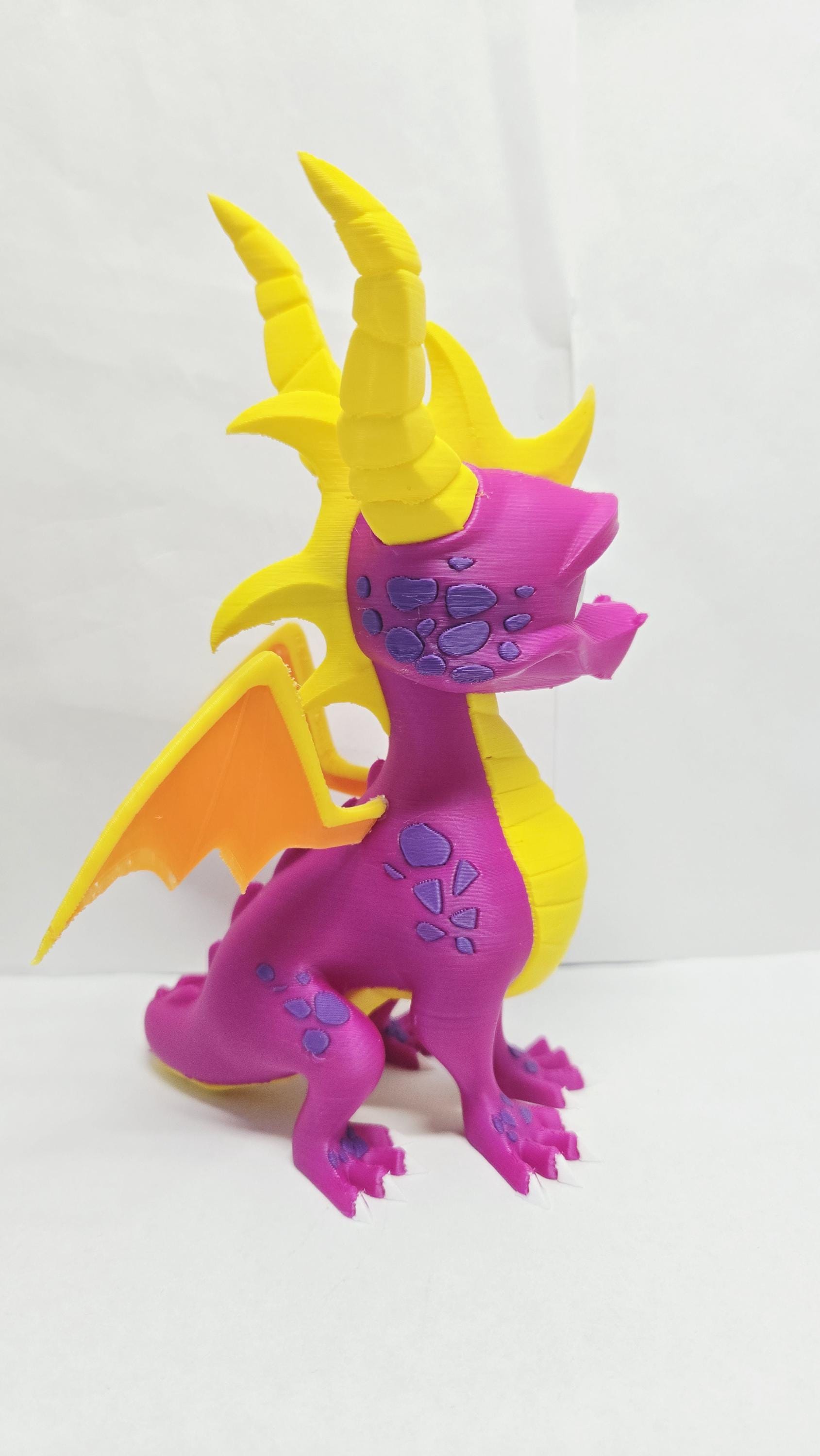 Three-quarter right side view of the Spyro figure showcasing the horn detail, wing shape, and overall scale