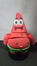 Close-up view of the 3D printed star flexi figure showcasing the vibrant pink and green color detail