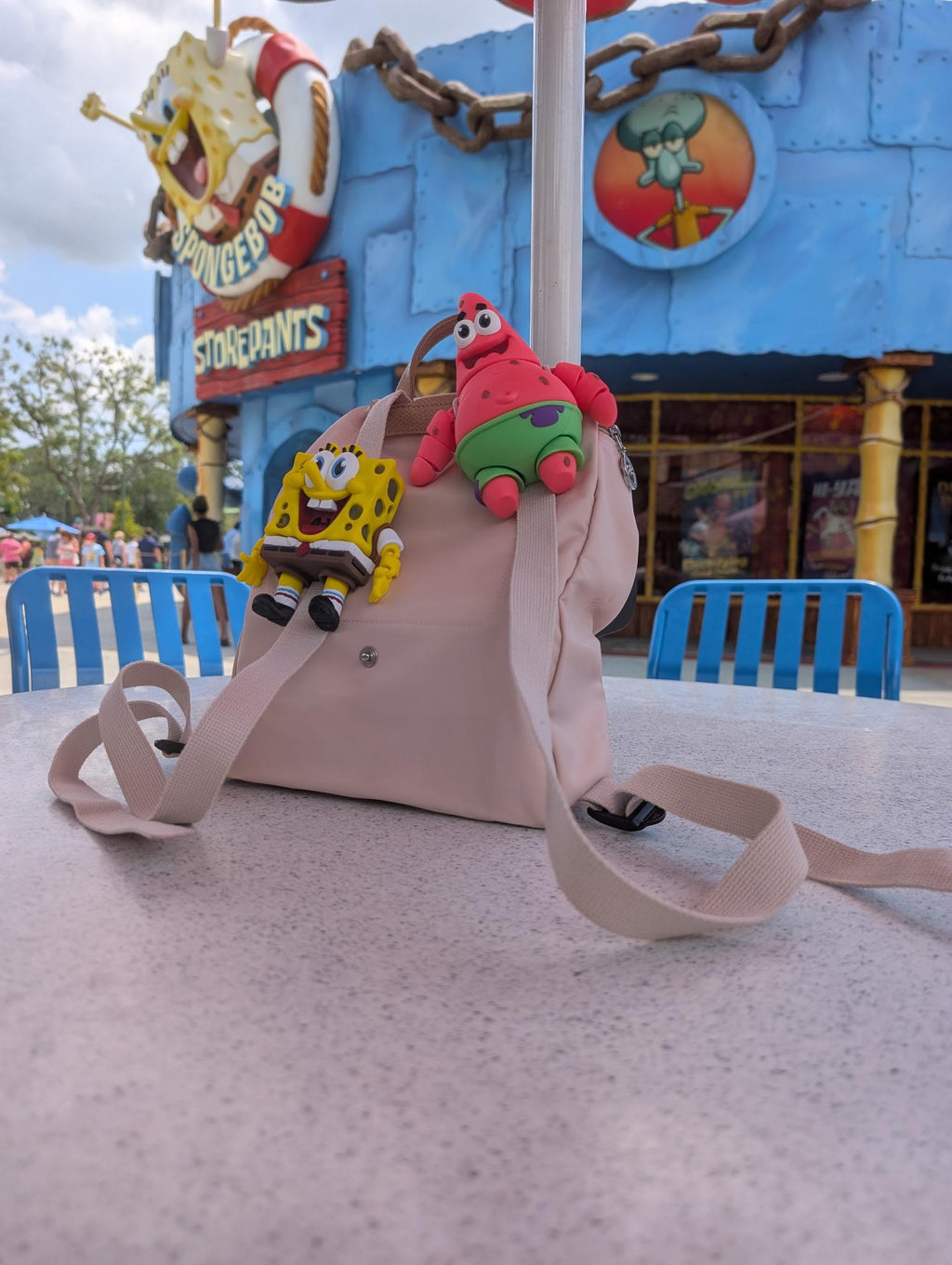Small articulated star flexi figure attached to a backpack during a day at the park