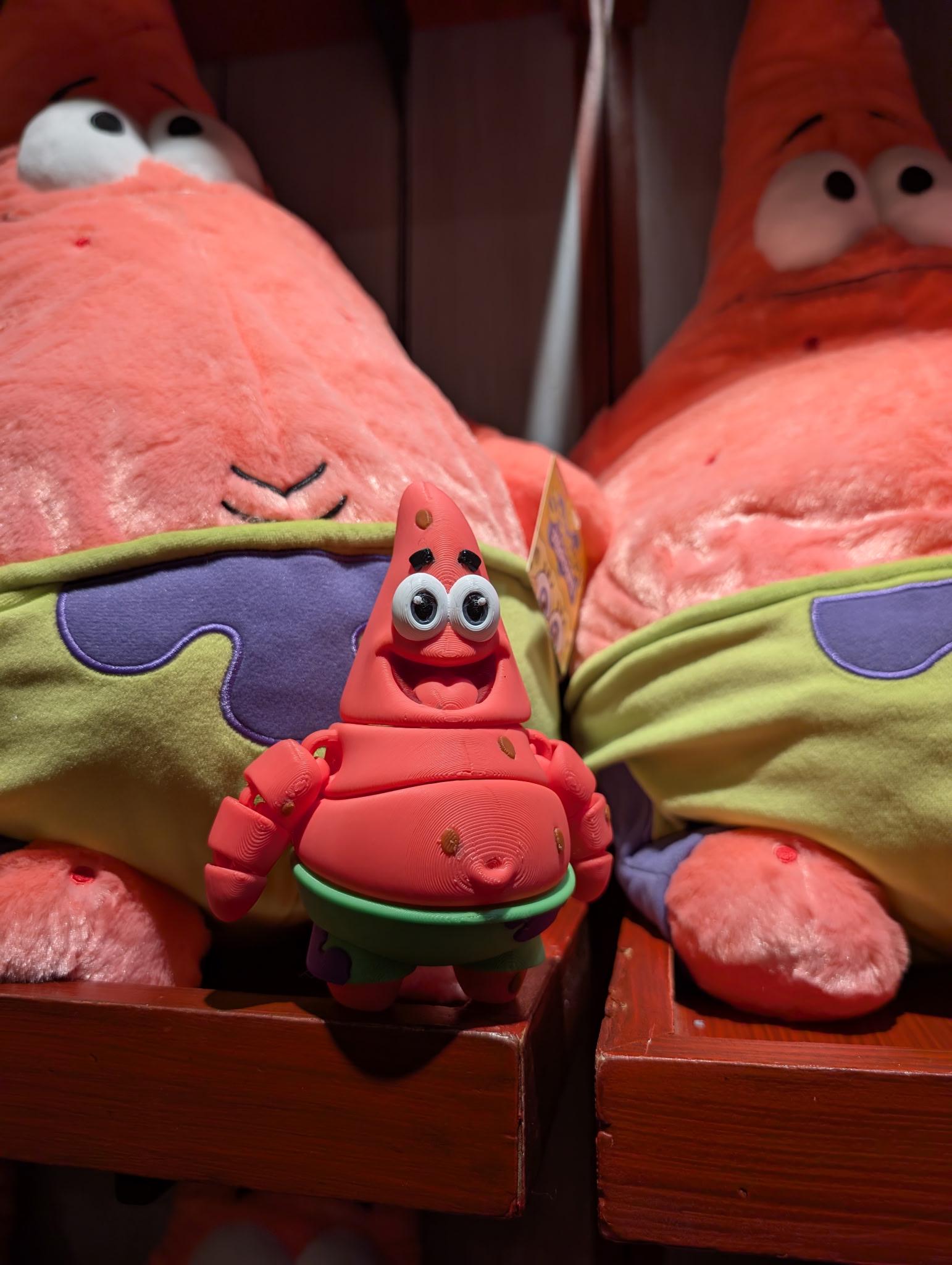 Small articulated star flexi figure displayed next to a large plush version for scale comparison