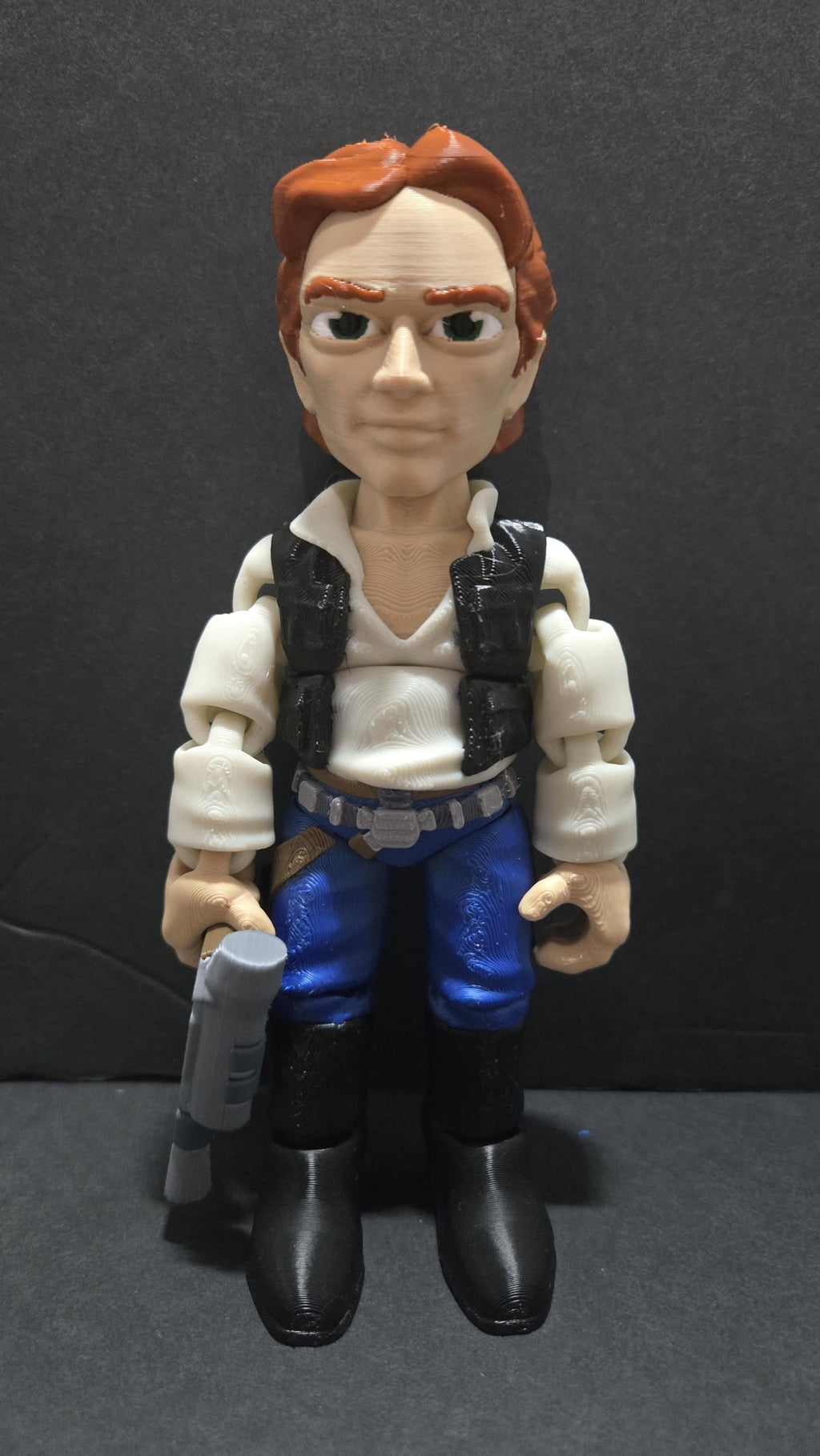 Full-color 3D printed Star Wars Han Solo flexi figure standing upright on a flat surface holding his DL-44 blaster as the main product view