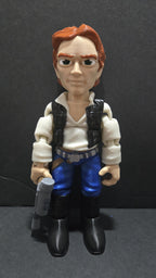 Full-color 3D printed Star Wars Han Solo flexi figure standing upright on a flat surface holding his DL-44 blaster as the main product view