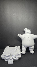 The 3D printed Stay Puft Marshmallow Man diorama disassembled into its modular parts, showing the giant figure separated from the detailed city street base