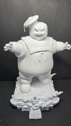 Straight front view of the unpainted 3D printed Stay Puft diorama on a black background showing the giant standing on a detailed city street base
