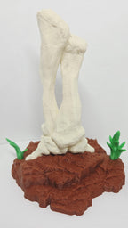 Rear view of the 3D printed dinosaur bone sculpture showcasing the clean texturing and back support mechanics of the base