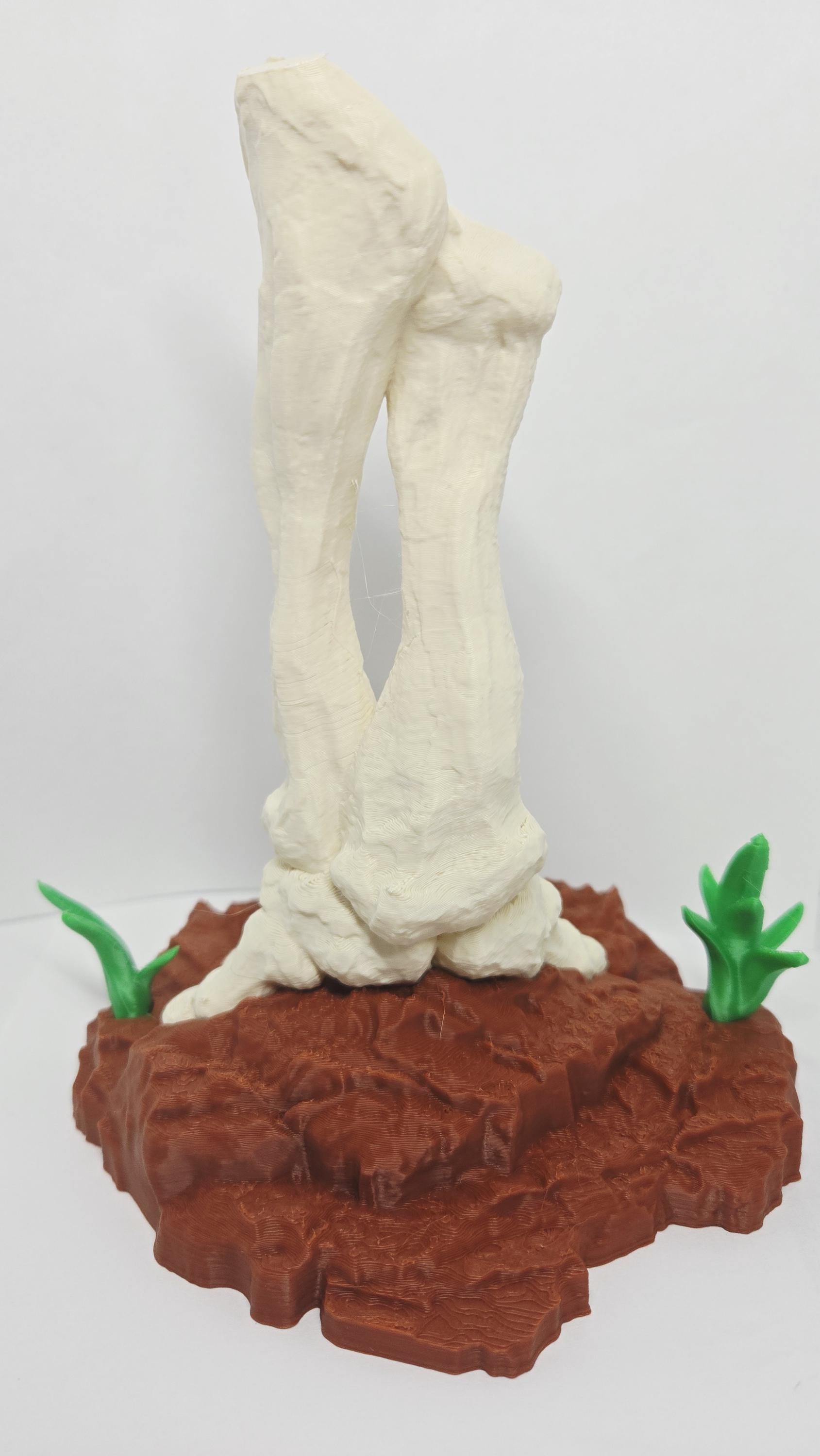 Rear view of the 3D printed dinosaur bone sculpture showcasing the clean texturing and back support mechanics of the base