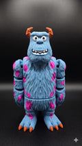 Full-color 3D printed Sully flexi figure standing upright against a dark, professional backdrop