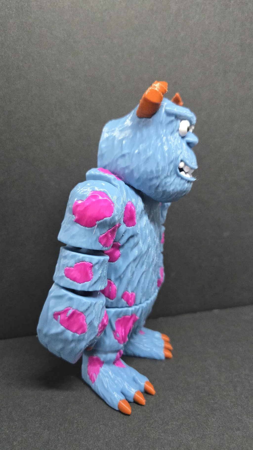 Side profile view of the 3D printed Sully flexi figure showcasing his fur texture and articulated joints