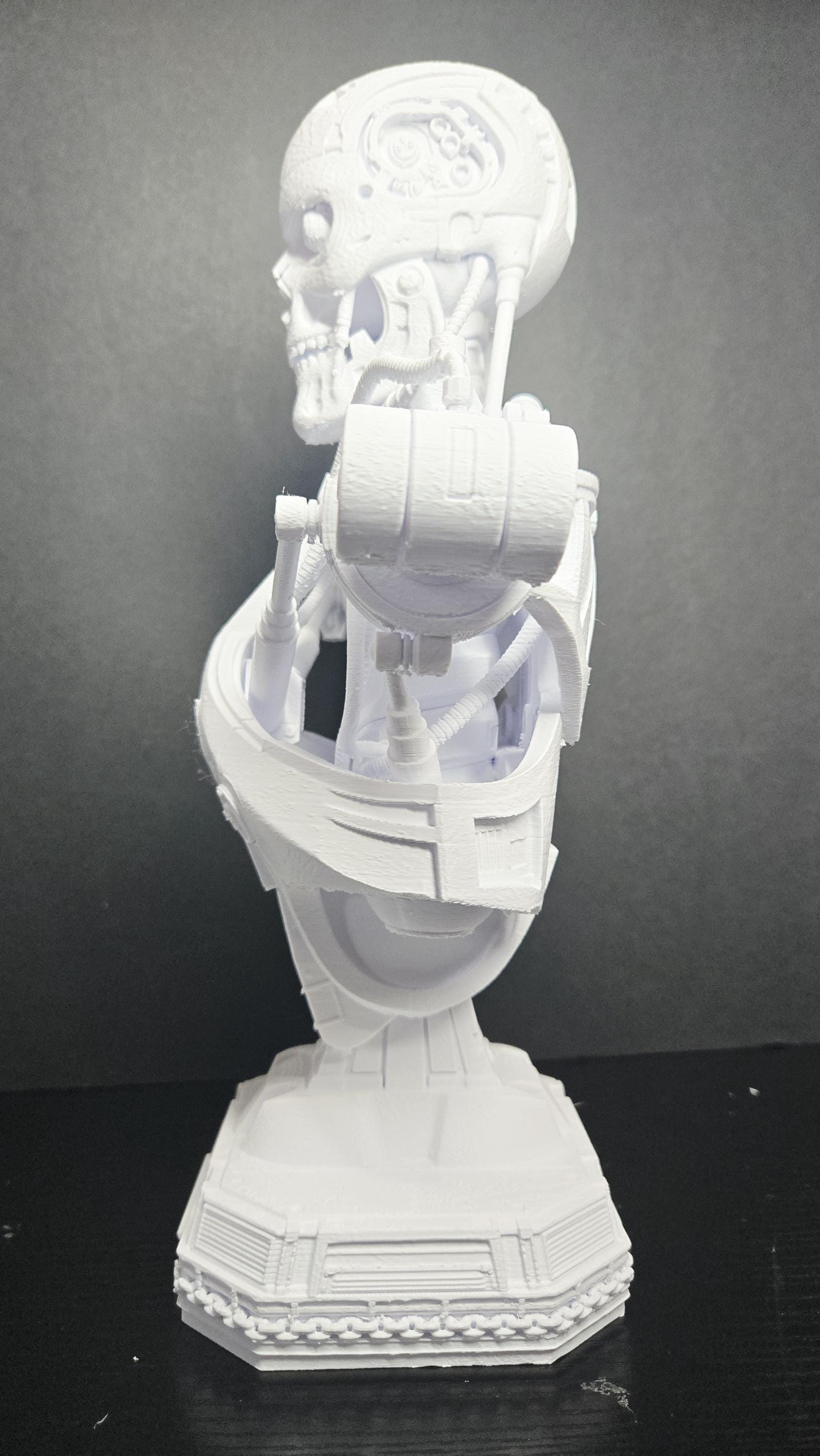 Left side profile view of the T-800 Terminator bust highlighting the intricate mechanical jaw and skull details
